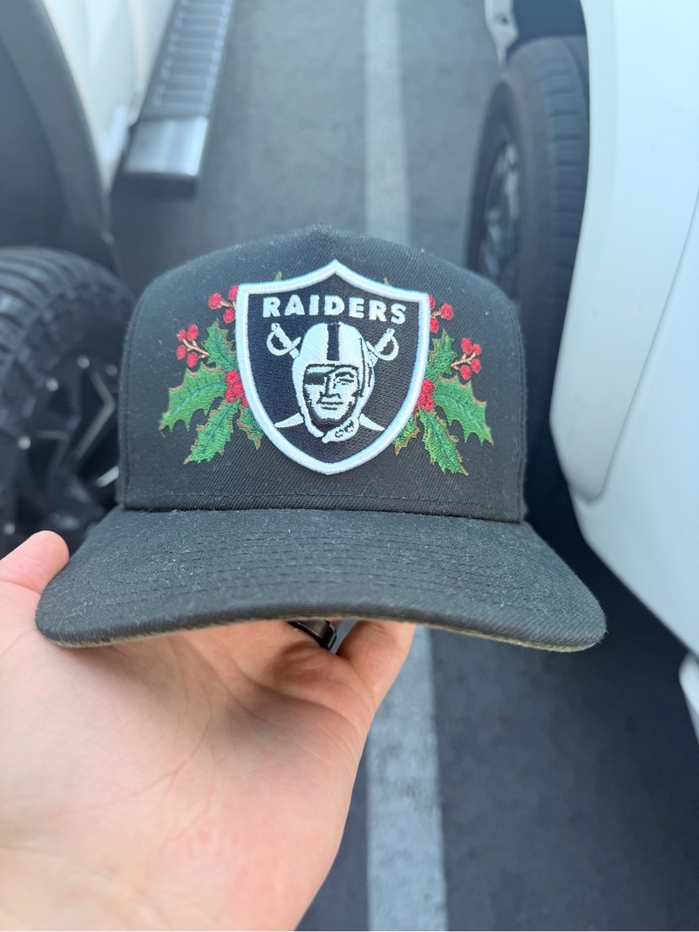 New Era Raiders Black Hat with Green & Red Holly Embroidery
